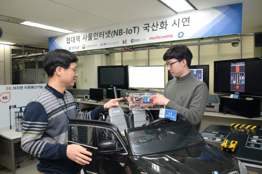 ETRI와 공동연구기관인 네스랩 연구자가 'NB-IoT 단말'을 이용한 차량침입 서비스를 시연하고 있다. ETRI 제공